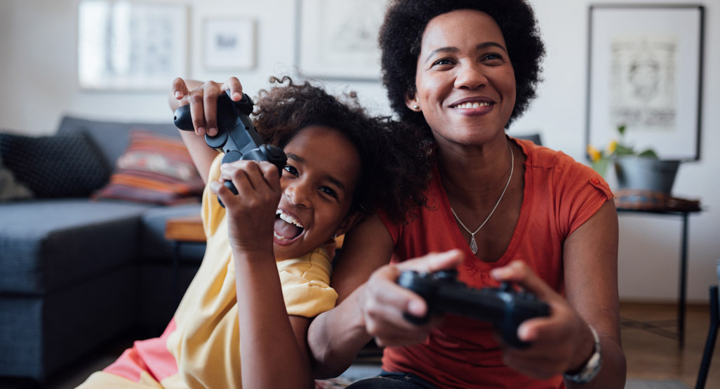 mom and daughter playing video game together